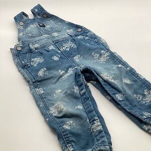 OshKosh B'gosh baby girl's floral knit denim overalls.